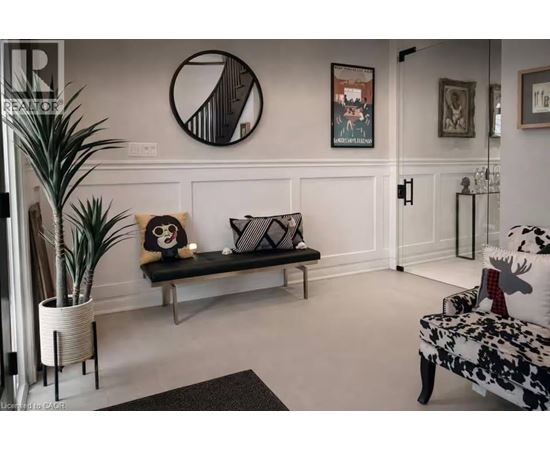 A living room with a bench, a couch, and a potted plant.