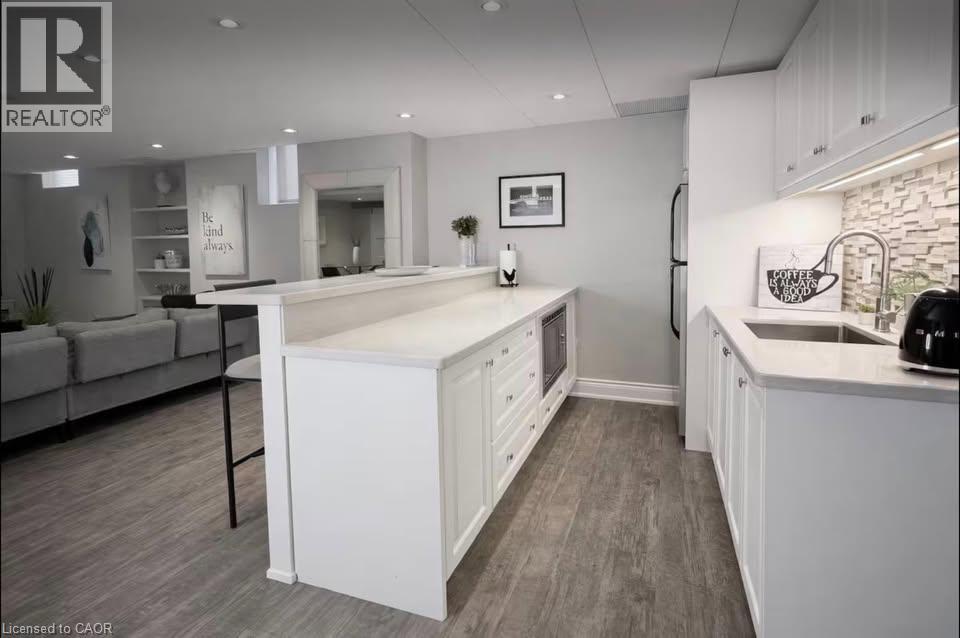 A modern kitchen with white cabinets and a large island.