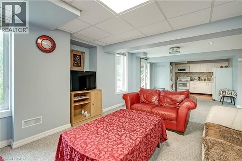 A living room with a red sofa and a television.
