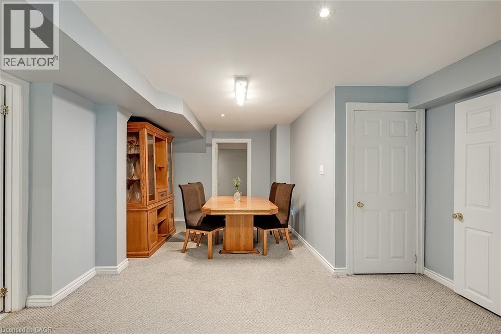A dining room with a wooden table and chairs.