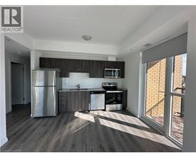 A modern kitchen with a refrigerator, microwave, and dishwasher.
