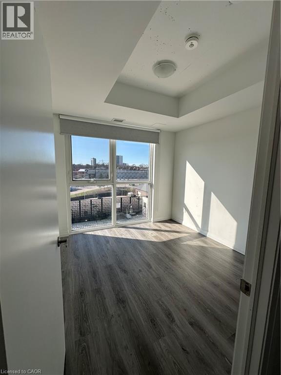 A room with a view of a body of water through a sliding glass door.