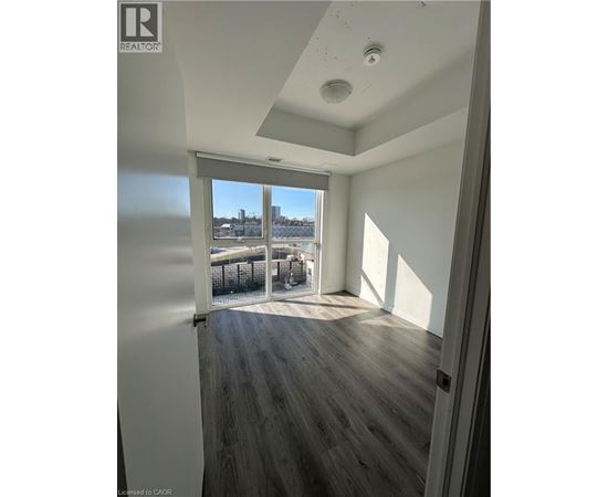 A room with a view of a body of water through a sliding glass door.