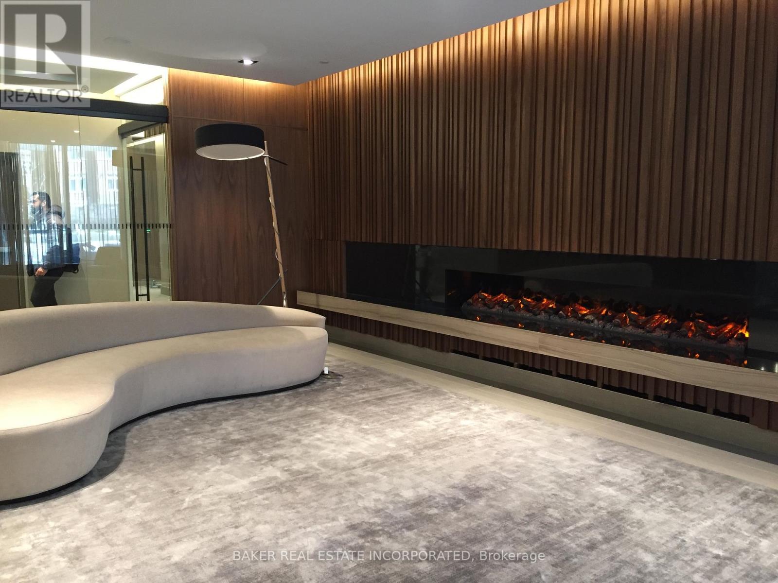 A modern living room with a fireplace and a white sofa.
