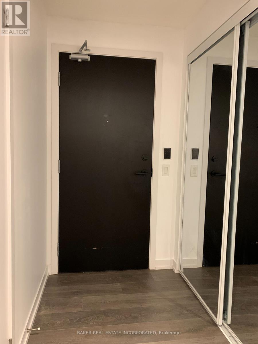 A black door in a white hallway.