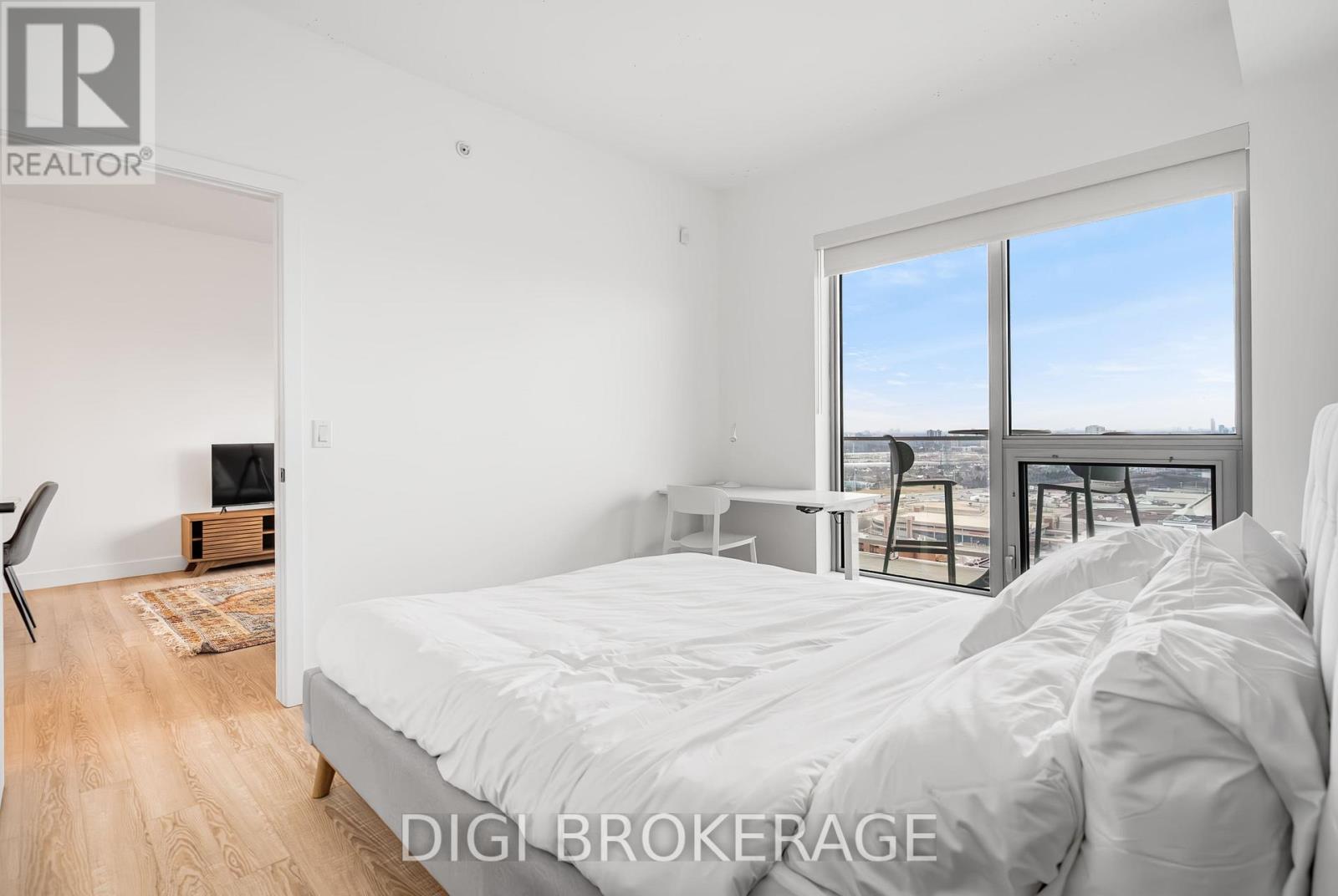 A bedroom with a large bed and a view of the outside.