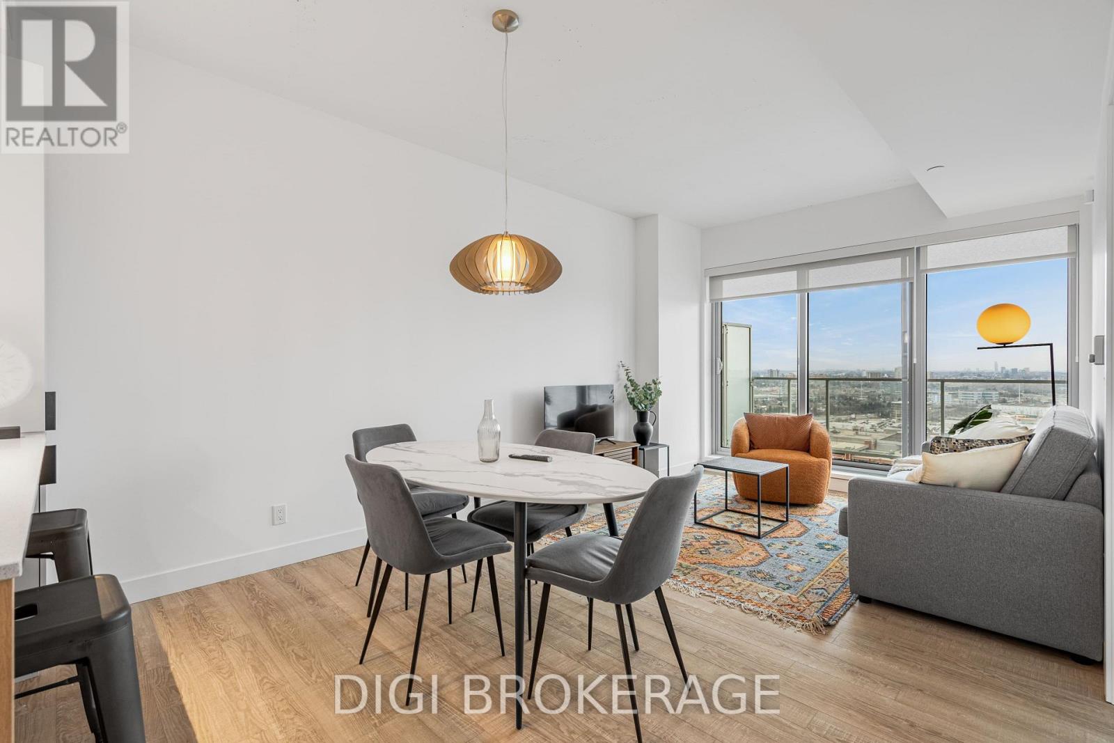 A modern dining room with a table set for four and a view of the outside.
