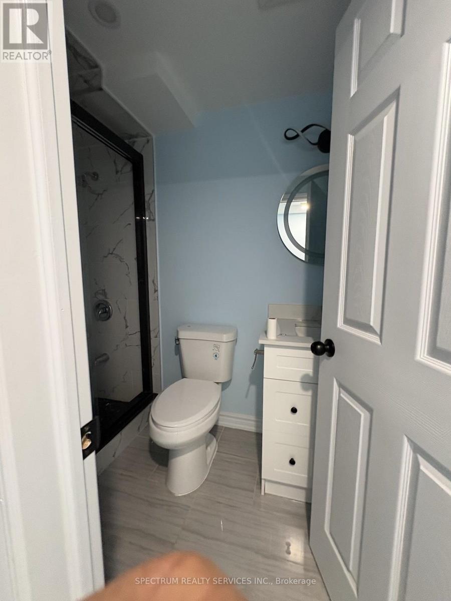 A white toilet and sink in a small bathroom.