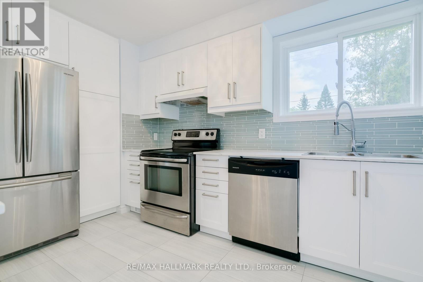 A kitchen with white cabinets and stainless steel appliances.