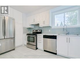 A kitchen with white cabinets and stainless steel appliances.