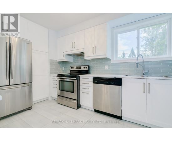 A kitchen with white cabinets and stainless steel appliances.