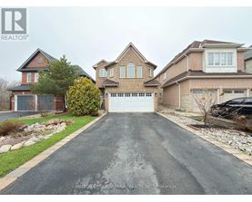 A house with a driveway in front of it.