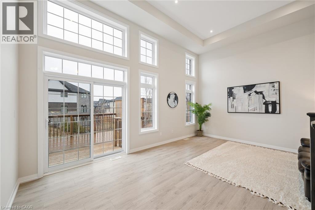 A realtor logo is on the wall in a spacious room.