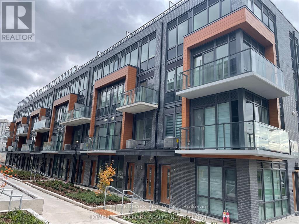 A modern multi-story building with balconies and glass windows.