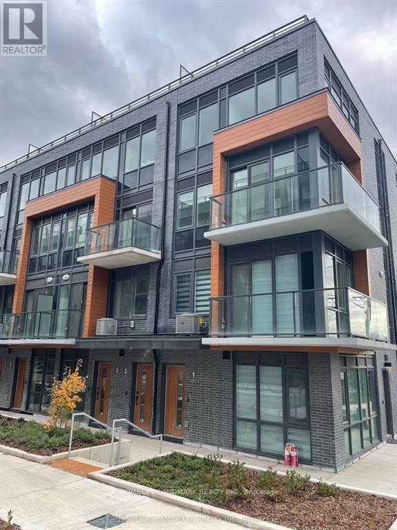A modern building with balconies and glass windows.