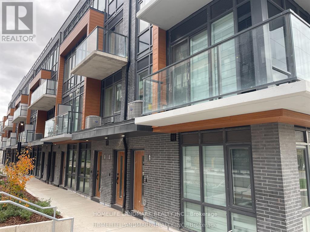 A modern building with balconies and glass doors.