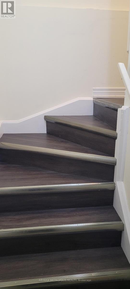 A set of stairs with a white railing.