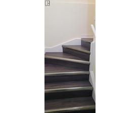 A set of stairs with a white railing.