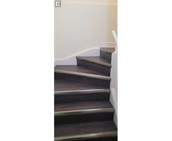 A set of stairs with a white railing.