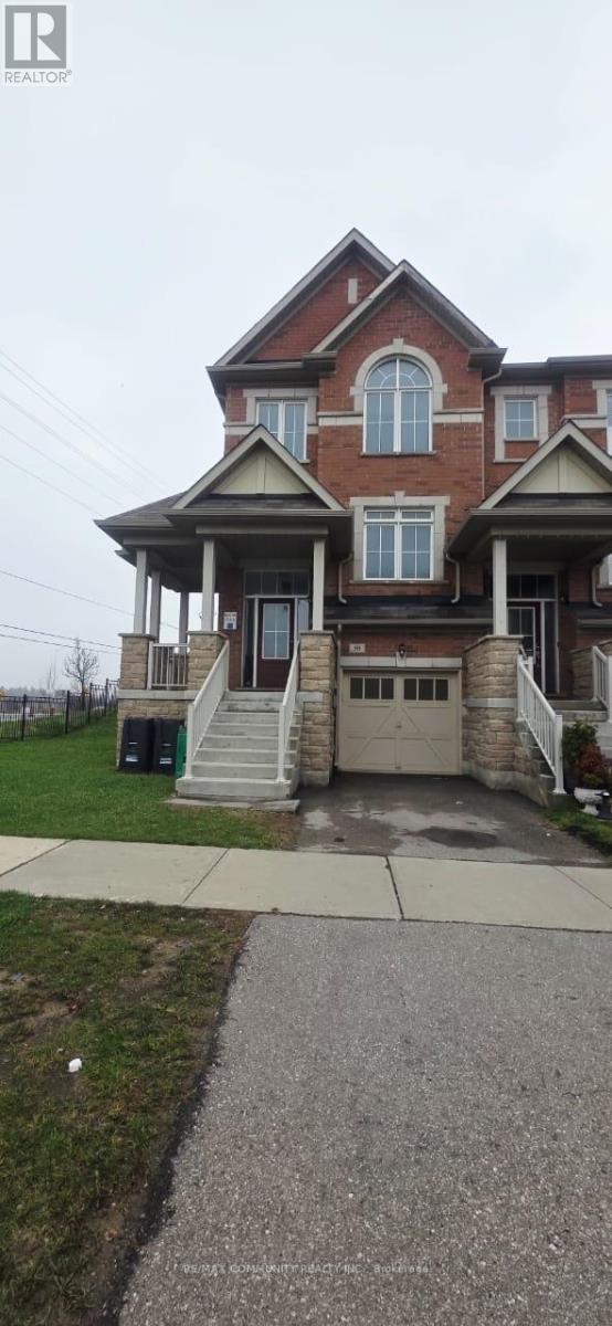 A two-story house with a front porch and a garage.