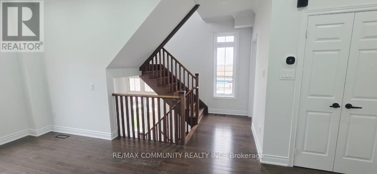 A wooden staircase in a house with a white door.