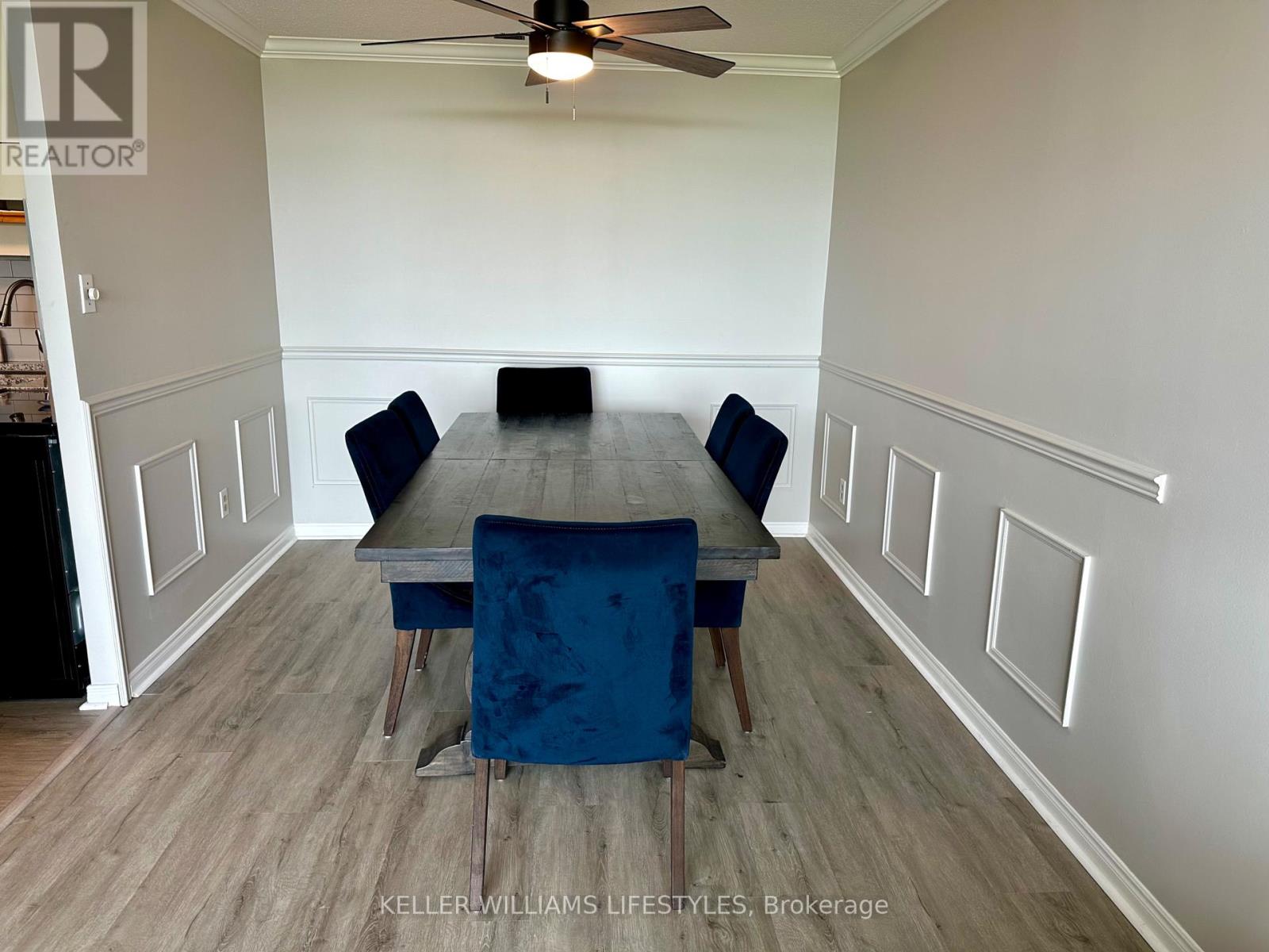 A dining room with a table and chairs.