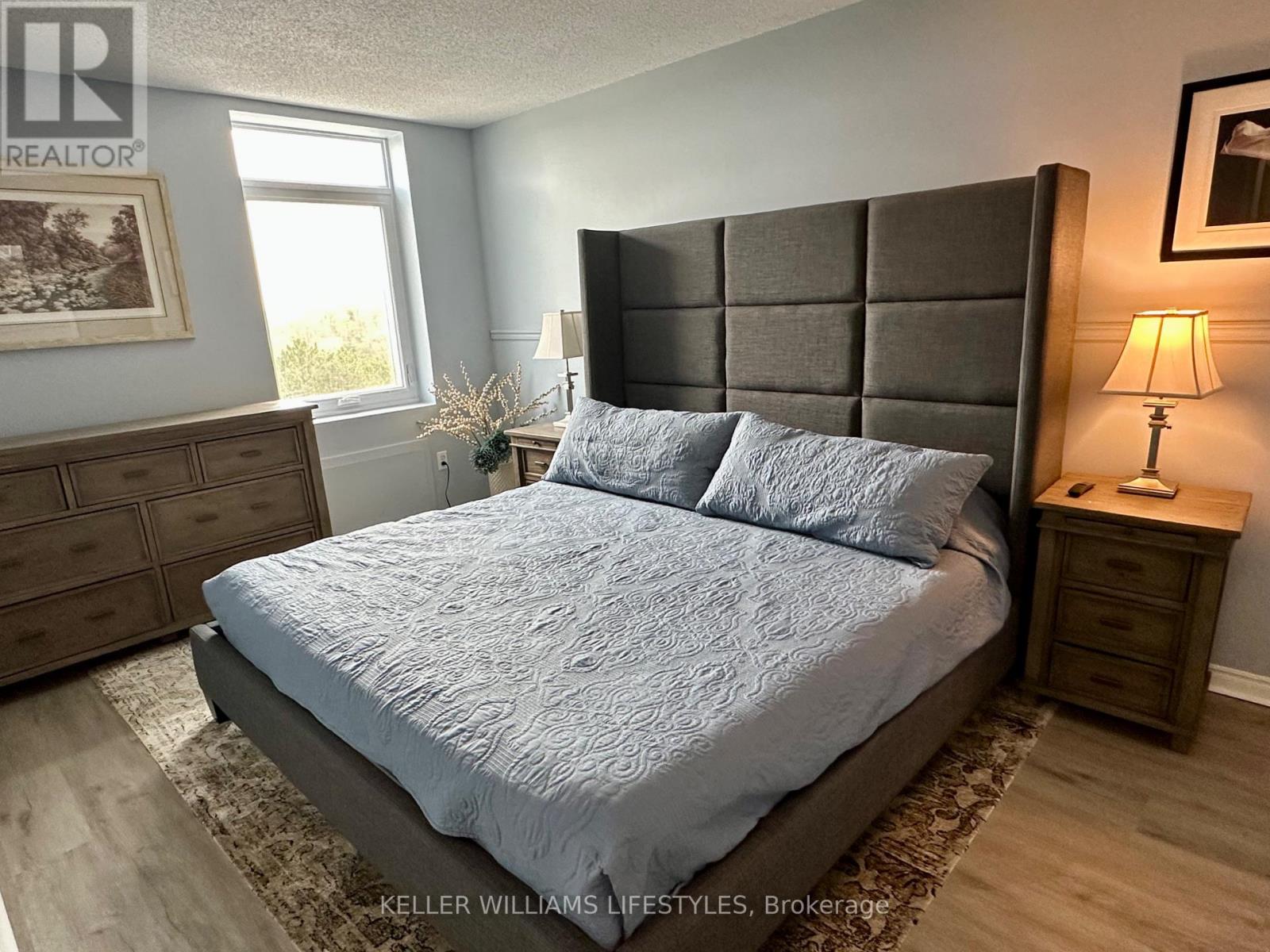 A bedroom with a large bed and a dresser.