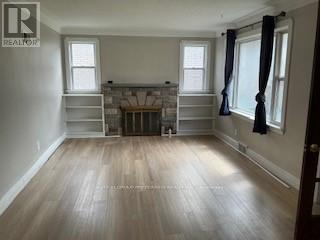 A room with a fireplace and wooden floors.