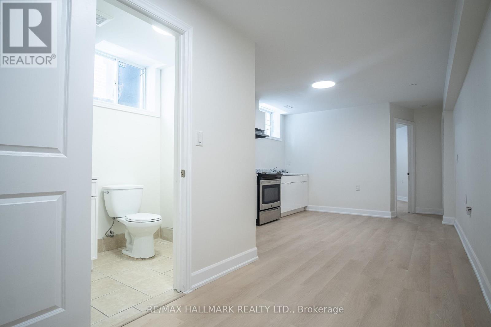 A white bathroom with a toilet and a sink.
