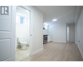 A white bathroom with a toilet and a sink.