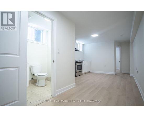 A white bathroom with a toilet and a sink.
