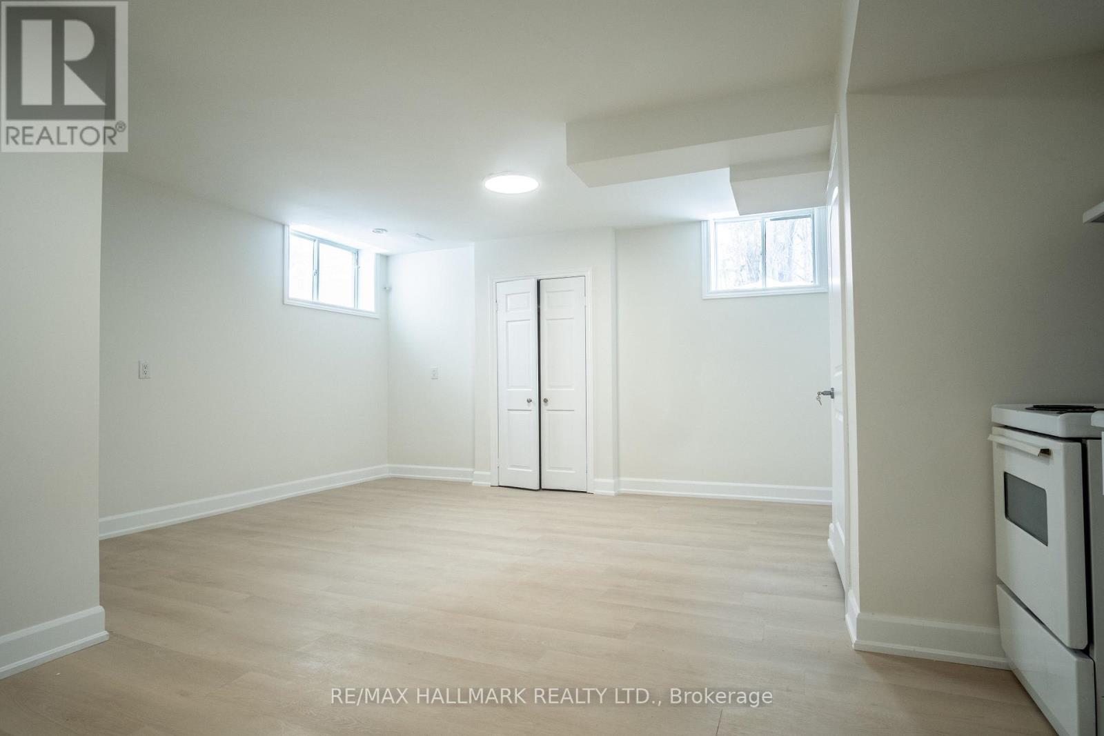 A white room with a door and a window.