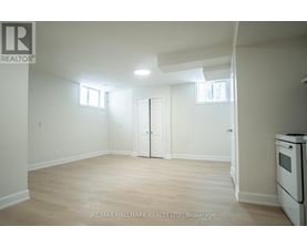 A white room with a door and a window.
