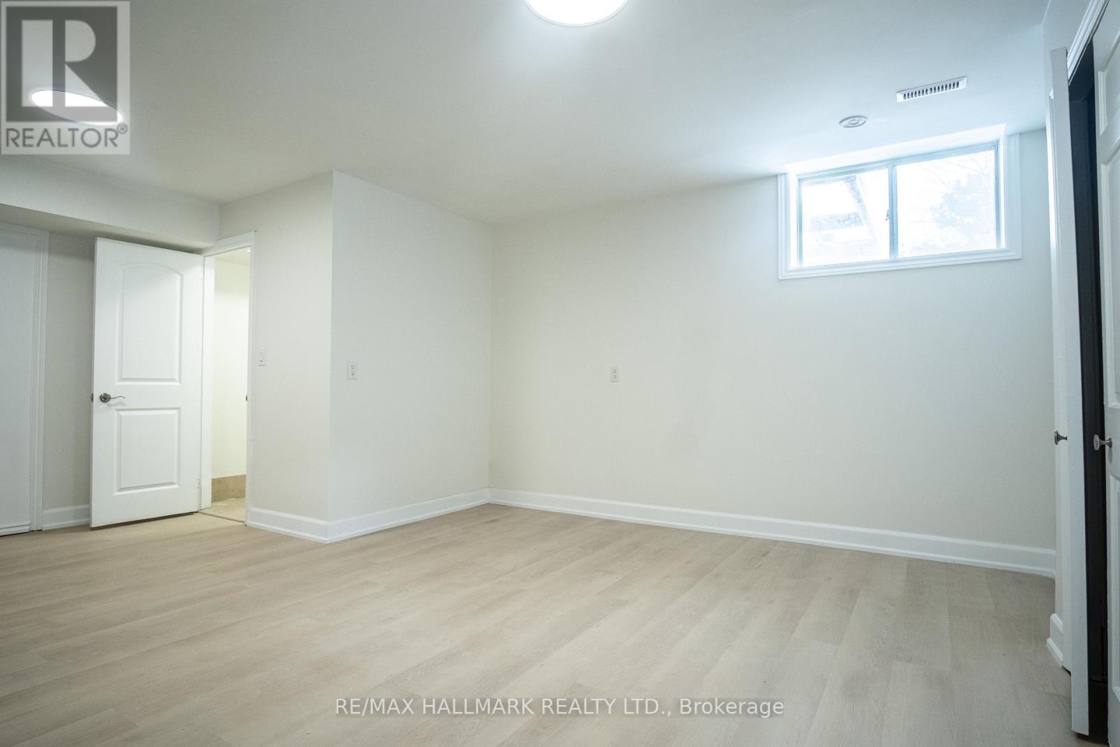 A white room with a door and a window.
