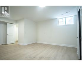 A white room with a door and a window.