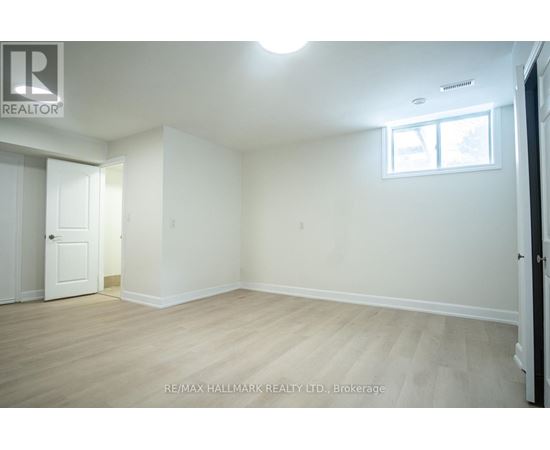 A white room with a door and a window.