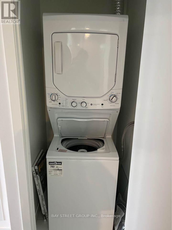A white dryer is in a small space.