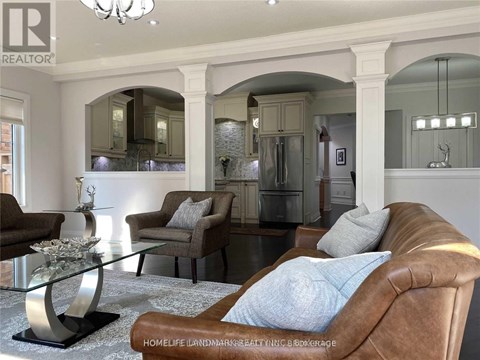 A living room with a brown leather chair and a glass coffee table.