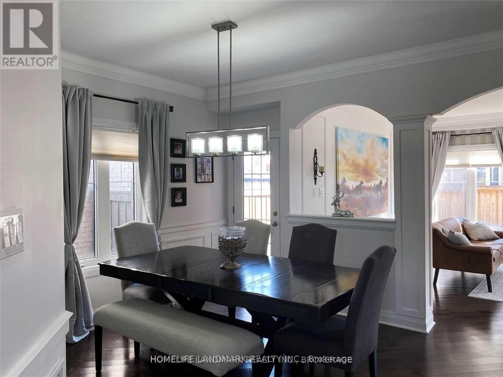 A dining room with a table set for four.
