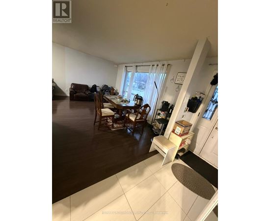 A living room with a dining table and chairs.
