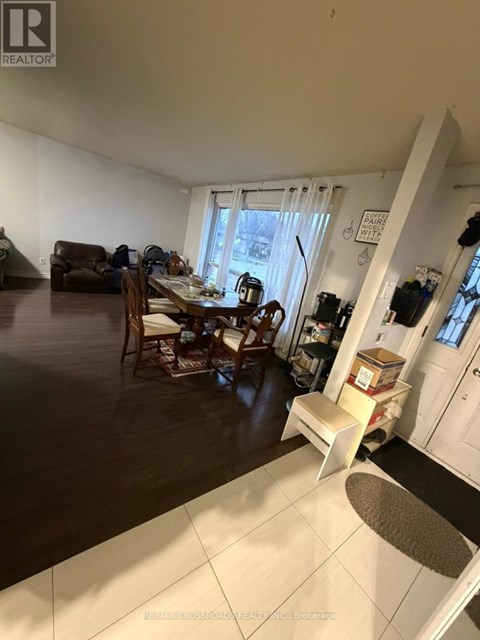 A living room with a dining table and chairs.