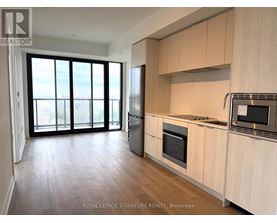 A kitchen with wooden cabinets and a microwave on the counter.