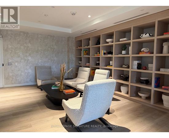 A living room with a black coffee table and a grey sofa.