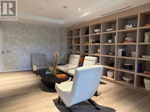 A living room with a black coffee table and a grey sofa.