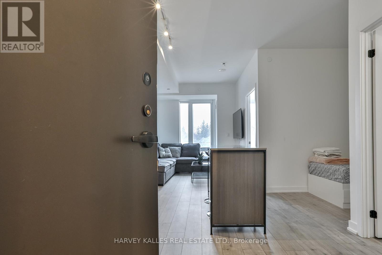 A realtor logo is on the door of a room.