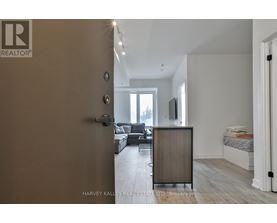 A realtor logo is on the door of a room.