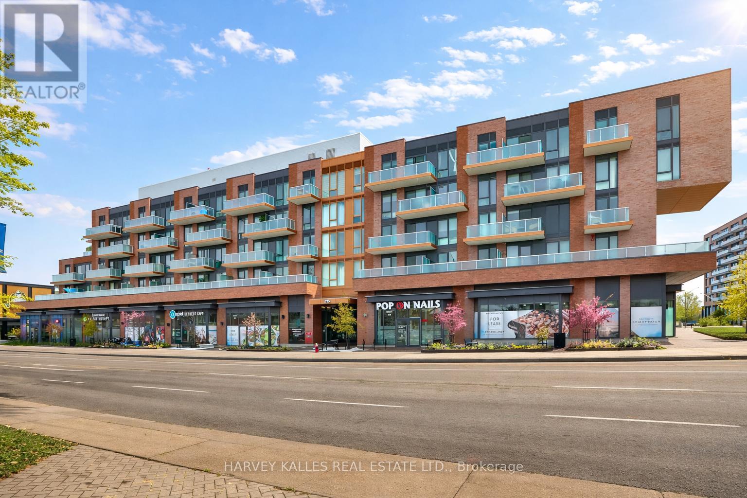 A modern apartment building with a nail salon on the ground floor.