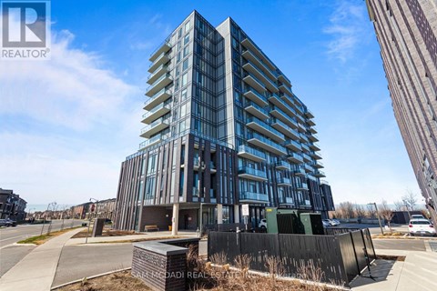 A modern multi-story building with a glass facade is under construction.