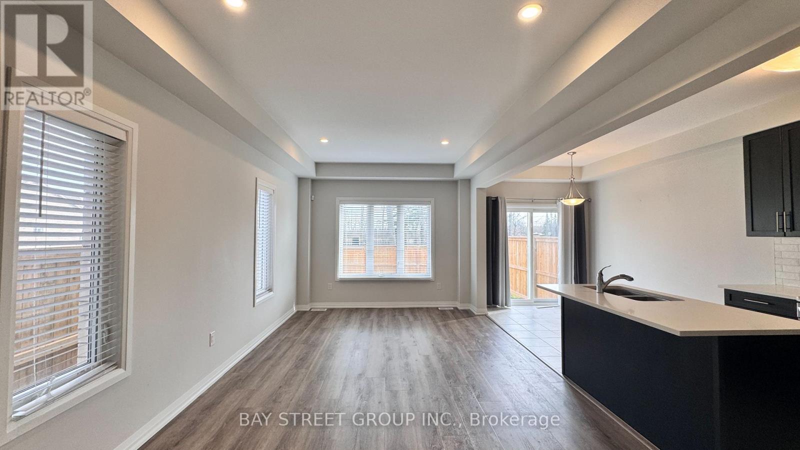 A spacious room with a large window and a view of a building outside.