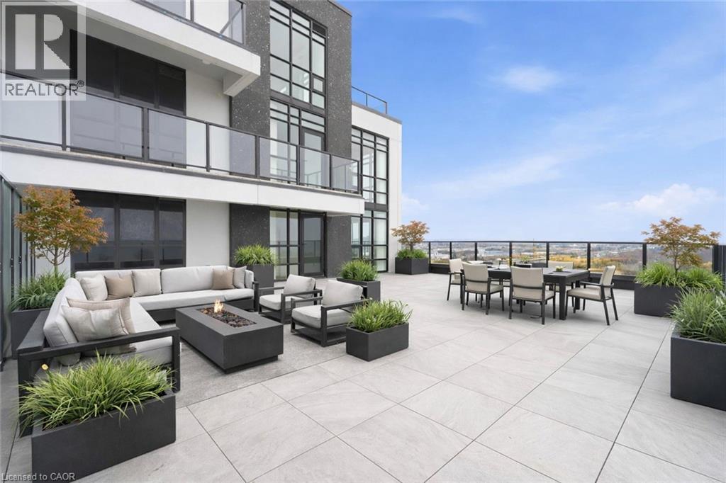 A modern patio area with a couch, chairs, and a table.